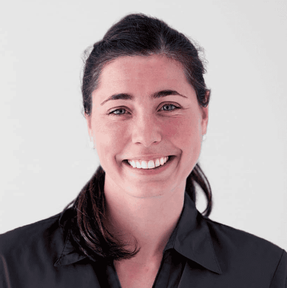 Veterinary nurse smiling, demonstrating wound management techniques for veterinary care.