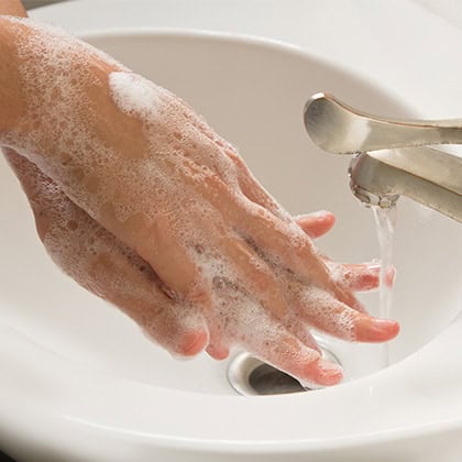 Washing hands with soap and water for infection control and hygiene.